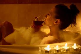 Woman in bubble bath with wine magic