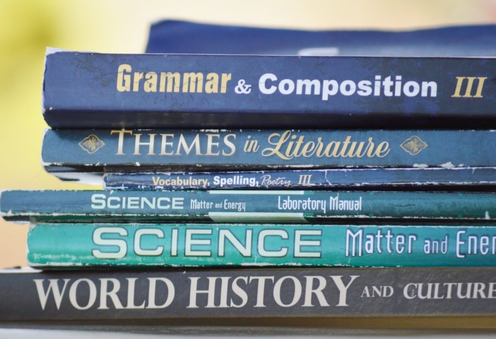 Accredited Online Homeschool: Stack of books for Grammar, Literature, Science, and History
